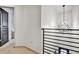 View of second story landing with designer light fixture and black metal banister at 1233 Miss Irene Ln, Lawrenceville, GA 30044