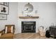 Elegant living room featuring a fireplace with black marble surround and modern decor at 1233 Miss Irene Ln, Lawrenceville, GA 30044