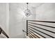 Modern staircase featuring a unique light fixture and sleek railing at 1233 Miss Irene Ln, Lawrenceville, GA 30044