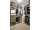 Organized walk-in closet with racks for hanging clothes and shelves for folded items and shoes at 1233 Miss Irene Ln, Lawrenceville, GA 30044