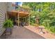 Landscaped backyard with lower wood deck, outdoor seating, mulch, and a decorative windmill at 139 Mountain Vista Blvd, Canton, GA 30115