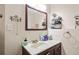 Close-up on the vanity with dark wood cabinets and a sink, complete with a mirror and lighting at 139 Mountain Vista Blvd, Canton, GA 30115