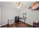This bedroom has wood floors, a ceiling fan, and a window at 139 Mountain Vista Blvd, Canton, GA 30115