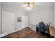 This bedroom has wood floors, a ceiling fan, and white trim at 139 Mountain Vista Blvd, Canton, GA 30115