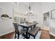 Dining room with plenty of light, featuring a large window with shutters and elegant lighting fixture at 139 Mountain Vista Blvd, Canton, GA 30115