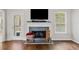 Close-up of the living room fireplace with a white mantel and decorative accessories at 139 Mountain Vista Blvd, Canton, GA 30115
