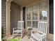 Close-up of covered front porch with rocking chairs and plantation shutters at 139 Mountain Vista Blvd, Canton, GA 30115