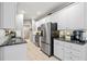 Modern kitchen featuring stainless steel appliances, granite counters, and white cabinetry at 139 Mountain Vista Blvd, Canton, GA 30115