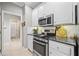 Elegant kitchen featuring stainless appliances, stone counters, and white cabinets at 139 Mountain Vista Blvd, Canton, GA 30115