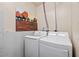 Bright laundry room featuring a new washer and dryer, complemented by colorful wall art at 139 Mountain Vista Blvd, Canton, GA 30115