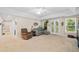 Bright living room featuring neutral carpeting, modern furniture, and glass patio doors leading to outdoor space at 139 Mountain Vista Blvd, Canton, GA 30115