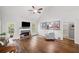 Bright living room with fireplace, hardwood floors, and view to exterior deck at 139 Mountain Vista Blvd, Canton, GA 30115