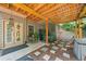 Outdoor living space featuring a hot tub, stone pavers, and a peaceful view of the surrounding landscape at 139 Mountain Vista Blvd, Canton, GA 30115