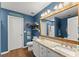 A blue-painted main bathroom with double granite vanity and a large mirror at 1920 Pilgrim Rd, Cumming, GA 30040