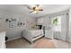 Bright bedroom featuring neutral tones, decorative shelving, and natural light from the window at 1920 Pilgrim Rd, Cumming, GA 30040