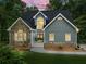 Beautiful home with stone and siding exterior, enhanced by professional outdoor lighting at 1920 Pilgrim Rd, Cumming, GA 30040