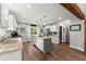 A kitchen with white cabinets, granite countertops and a grey kitchen island with seating at 1920 Pilgrim Rd, Cumming, GA 30040