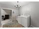 Laundry room with modern washer and dryer, utility sink, and storage at 1920 Pilgrim Rd, Cumming, GA 30040
