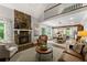 Open-concept living room with a stone fireplace, seamlessly connected to the dining area at 1920 Pilgrim Rd, Cumming, GA 30040