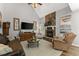 Cozy living room featuring a stone fireplace, comfortable seating, and natural light at 1920 Pilgrim Rd, Cumming, GA 30040