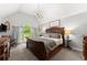 A main bedroom featuring a vaulted ceiling, large window, and wood furniture at 1920 Pilgrim Rd, Cumming, GA 30040