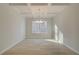 Well-lit dining room featuring coffered ceilings, chandelier, and a large window at 2525 Dixon Pl, Lawrenceville, GA 30045