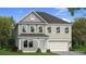 Charming two-story home featuring light brick, dormer window, and a welcoming two-car garage at 2525 Dixon Pl, Lawrenceville, GA 30045