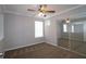 This bedroom features neutral paint, carpeted floors, and a ceiling fan with a lighting fixture at 5465 Mountain Top Pl, Cumming, GA 30041