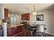Bright kitchen with wood cabinets, granite counters, stainless appliances, and an adjacent dining area at 5465 Mountain Top Pl, Cumming, GA 30041