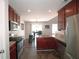 Well-equipped kitchen with granite countertops, stainless steel appliances, and dark wood cabinets at 5465 Mountain Top Pl, Cumming, GA 30041