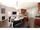 Open kitchen and dining area featuring stainless appliances and a cozy breakfast table near the fireplace at 5465 Mountain Top Pl, Cumming, GA 30041