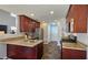 Well-lit kitchen features stainless steel appliances, granite countertops, and wooden cabinets at 5465 Mountain Top Pl, Cumming, GA 30041