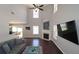 Bright living room with tall ceilings, fireplace, hardwood floors, and large windows at 5465 Mountain Top Pl, Cumming, GA 30041