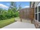 A fenced back patio with new concrete, trees, and green grass at 1360 Sugar Glen Ct, Lawrenceville, GA 30044