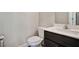Bathroom features a toilet and a vanity with dark wood cabinets and a white countertop at 1360 Sugar Glen Ct, Lawrenceville, GA 30044