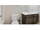 A charming bathroom featuring a modern sink and vanity with sleek, dark wood at 1360 Sugar Glen Ct, Lawrenceville, GA 30044