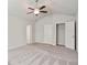 Bedroom features carpet, a ceiling fan, and access to a closet at 1360 Sugar Glen Ct, Lawrenceville, GA 30044