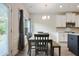 Dining area with modern lighting, stylish furniture, and natural light at 1360 Sugar Glen Ct, Lawrenceville, GA 30044