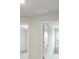 Hallway featuring neutral paint, carpeted floors, and doors leading to other rooms at 1360 Sugar Glen Ct, Lawrenceville, GA 30044