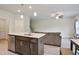 Open kitchen with granite countertops, stainless steel appliances, and adjoining living area at 1360 Sugar Glen Ct, Lawrenceville, GA 30044