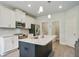 Modern kitchen features white cabinets, stainless steel appliances, granite countertops, and a center island at 1360 Sugar Glen Ct, Lawrenceville, GA 30044