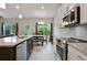 Modern kitchen featuring granite countertops, stainless steel appliances, and white cabinets at 1360 Sugar Glen Ct, Lawrenceville, GA 30044