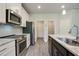 Modern kitchen with granite countertops, stainless steel appliances and white cabinets at 1360 Sugar Glen Ct, Lawrenceville, GA 30044