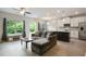 Open-concept living room with modern lighting, stainless appliances, and large windows at 1360 Sugar Glen Ct, Lawrenceville, GA 30044
