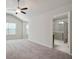 Spacious main bedroom with carpet, a ceiling fan and an ensuite bathroom with a glass shower at 1360 Sugar Glen Ct, Lawrenceville, GA 30044