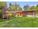 Green backyard features a lush lawn, stone walkways, a brick house exterior, and a partially covered deck at 4544 Ridgeview Dr, Powder Springs, GA 30127