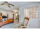 Bright bedroom boasts natural light from a decorative window; rocking chair and bed offer a comfortable space at 4544 Ridgeview Dr, Powder Springs, GA 30127