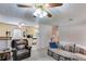 Cozy living room featuring a ceiling fan with lighting and view into adjacent kitchen with white appliances and cabinetry at 4544 Ridgeview Dr, Powder Springs, GA 30127
