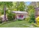 Backyard outbuilding featuring a quaint design, complete with decorative signage, window boxes, and colorful shutters at 4544 Ridgeview Dr, Powder Springs, GA 30127