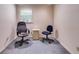 Small room with blue carpeting, painted walls and a window providing natural light, furnished with two office chairs at 4544 Ridgeview Dr, Powder Springs, GA 30127